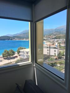 a room with a window with a view of the ocean at Rooms with view in Himare +75 photos