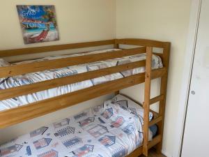 a bedroom with two bunk beds in a room at 449 Driftwood in Scratby