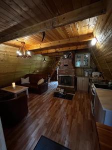 a large living room with a couch and a table at Lenivka in Hnilčík +8 photos