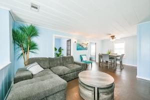 a living room with a couch and a table at Beach lovers dream come true walking distance to the sandy shores in Galveston