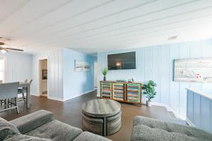 a living room with a couch and a table at Beach lovers dream come true walking distance to the sandy shores in Galveston