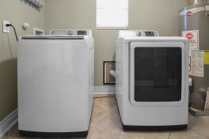 a microwave and a refrigerator in a room at Hot Tub Relax. Vacation Mode Activated in Galveston