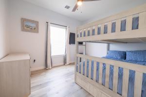 a bedroom with a bunk bed and a window at Get ready to soak up the sun at Villa Caman in Galveston
