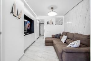 a living room with a couch and a tv at Endless Seaview Patalavaca in Patalavaca