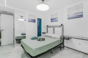 a hospital room with a bed and a mirror at Endless Seaview Patalavaca in Patalavaca