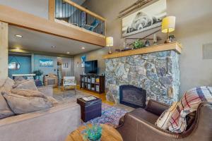 a living room with a large stone fireplace at 3 Bed 3 Bath Vacation home in Schweitzer Mountain in Sandpoint