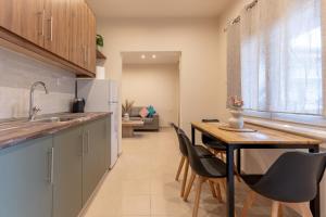 a kitchen with a table and chairs and a dining room at Al Centro No4 in Stavros