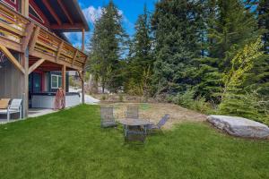a patio with a table and chairs in a yard at 3 Bed 3 Bath Vacation home in Schweitzer Mountain in Sandpoint