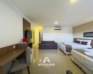 a hotel room with a bed and a couch at Arituba Park Hotel in Natal
