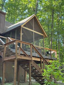 a large wooden house with a large deck at Mountainside w Fireplace, Fire Pit, Deck, & WiFi in Smith Crossroads