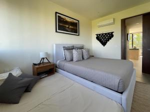 a bedroom with a large bed and a table at Sunrise 2BR Apt Steps from the Beach with Pool View in Holbox Island +30 photos