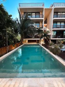 an empty swimming pool in front of a building at Sunrise 2BR Apt Steps from the Beach with Pool View in Holbox Island