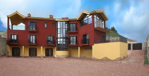 a red and yellow building with aventh floor at Casa Arrieta in Castejón de Valdejasa