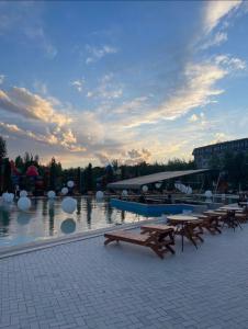 a group of picnic tables and a boat in the water at Issyk Kul in Korumdy