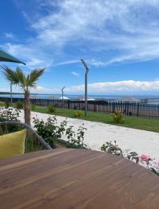 a wooden table with a view of the ocean at Issyk Kul in Korumdy +14 photos