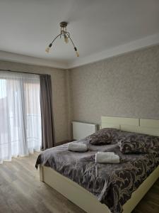a bedroom with a bed with two pillows on it at Bakuriani apartment 205 Tsakadze st 20 in Bakuriani