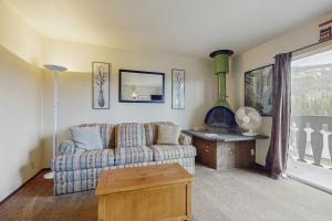 a living room with a couch and a fireplace at Red Cricket 22 in Sandpoint