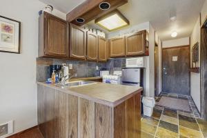 a kitchen with wooden cabinets and a counter top at Red Cricket 22 in Sandpoint
