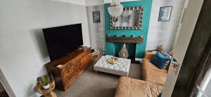 a living room with a flat screen tv and a couch at Lovely house in Redditch in Headless Cross