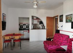 a kitchen and a living room with a table and chairs at Apartments Vesna in Maslinica