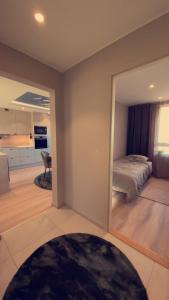a bedroom with a bed and a living room at Penthouse apartment with sauna, balcony and free coffe in Bergen