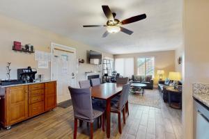 a kitchen and living room with a table and a ceiling fan at 11529 Snowpeak Way #619 in Truckee
