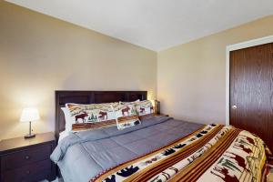 a bedroom with a large bed and a nightstand at 11529 Snowpeak Way #619 in Truckee