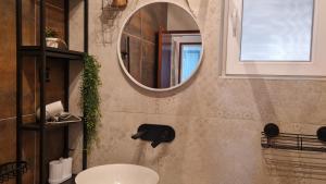 a bathroom with a sink and a mirror on the wall at Apartment Vjera in Tisno