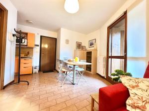 a living room with a red couch and a table at Campo Smith - Les Floralies free parking in Bardonecchia