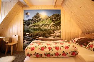 a bedroom with two beds with a mountain mural at Góralski Domek Waluś Zakopane - ŚCISŁE CENTRUM - Jedyny domek na Krupówkach in Zakopane