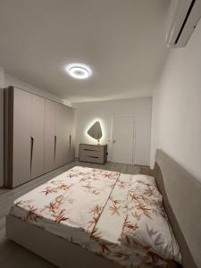 a bedroom with a large bed in a room at Mira's Apartment in Shkodër