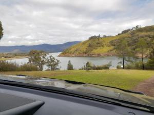 a view of a lake from a car window at Coves Cottage in Piries +10 photos