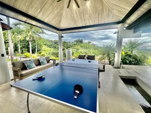 a living room with a pool table in a house at New Exclusive Retreats Tamarindo 8 Bedroom Villa in Tamarindo