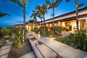 a house with palm trees in front of it at New Exclusive Retreats Tamarindo 8 Bedroom Villa in Tamarindo
