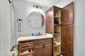 a bathroom with a sink and a mirror at It's A Vibe- less than 10mins Capital,Hospitals,FAMU,&FSU in Tallahassee +41 photos