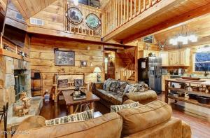 a living room filled with furniture in a cabin at Bear Country Cabin in Sevierville
