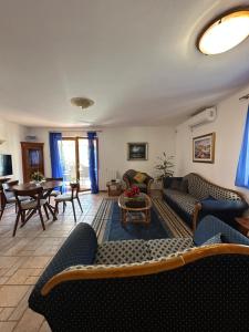 a living room with couches and chairs and a table at Meridian Hotel in Budva