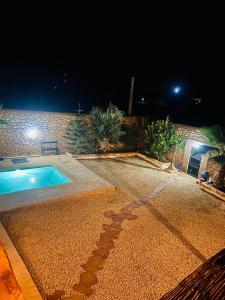 a swimming pool in a yard at night at Villa Des Arts in Essaouira