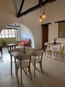 a living room with tables and chairs and a couch at El Aldabón - Villa de Leyva in Villa de Leyva
