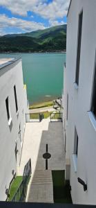 a view of a lake from between two buildings at Royal Terrace Konjic in Železnička Stanica Ostrožac