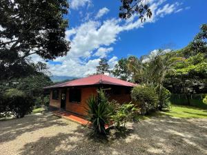 a small house with a red roof at Eco Boutique House in La Vega