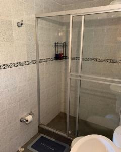 a shower stall in a bathroom with a toilet at Eco Boutique House in La Vega +23 photos