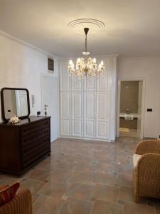a living room with a mirror and a chandelier at Montenegro Seaside Lux Apartment in Petrovac na Moru
