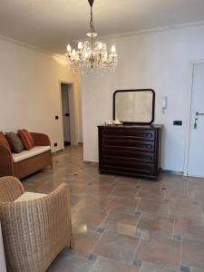 a living room with a mirror and a dresser at Montenegro Seaside Lux Apartment in Petrovac na Moru