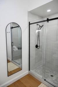 a shower with a glass door in a bathroom at St. Louis Luxury Home 3BR/3.5BA Near Everything in Soulard +32 photos