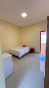 a bedroom with a bed in the corner of a room at Hotel Soares in Anapurus