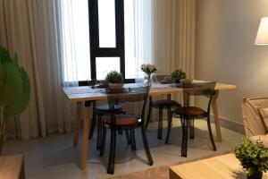 a dining room table with stools in a living room at Apartment in Alkhoud Muscat in Maţār as Sīb ad Duwalī