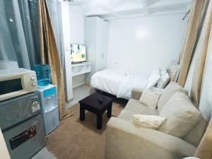 a living room with a couch and a bed at Cities bnbs in Gatunga +8 photos