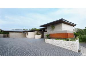 a house with a brick driveway in front of it at Tanegashima Araki Hotel Bekkan - Vacation STAY 57001v in Nishinoomote