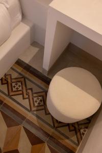 a white stool sitting on a floor next to a desk at Donna Veneranda in Vieste +100 photos